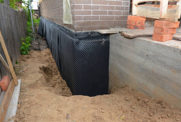 Happy homeowners after waterproofing job in Alpha